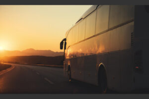 White,Bus,Driving,On,Road,Towards,The,Setting,Sun