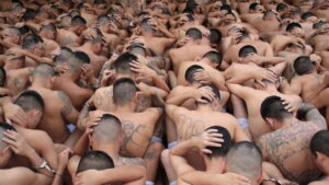 Gang members wait outside their cells during a search at the Ciudad Barrios jail